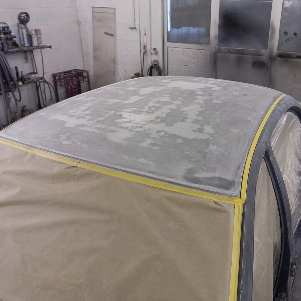Car roof panel being prepped for refinishing